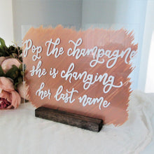 Load image into Gallery viewer, Pop the champagne she's changing her last name bridal shower acrylic bubbly bar mimosa bar champagne bar sign