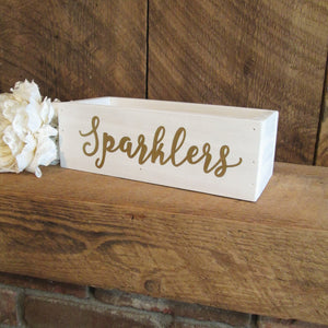 White and gold sparklers hold by Perryhill Rustics