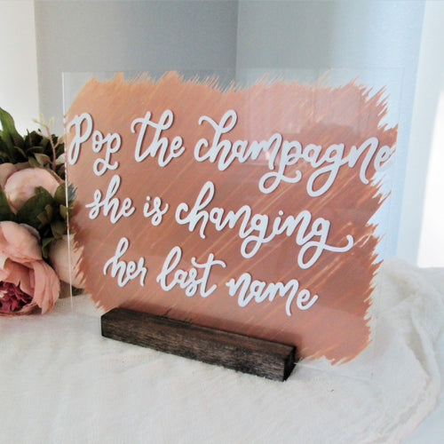 Pop the champagne she's changing her last name bridal shower acrylic bubbly bar mimosa bar champagne bar sign