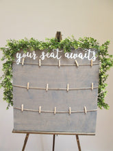 Load image into Gallery viewer, Weathered grey your seat awaits. Hand painted plywood seating chart sign. Beach themed wedding decor.
